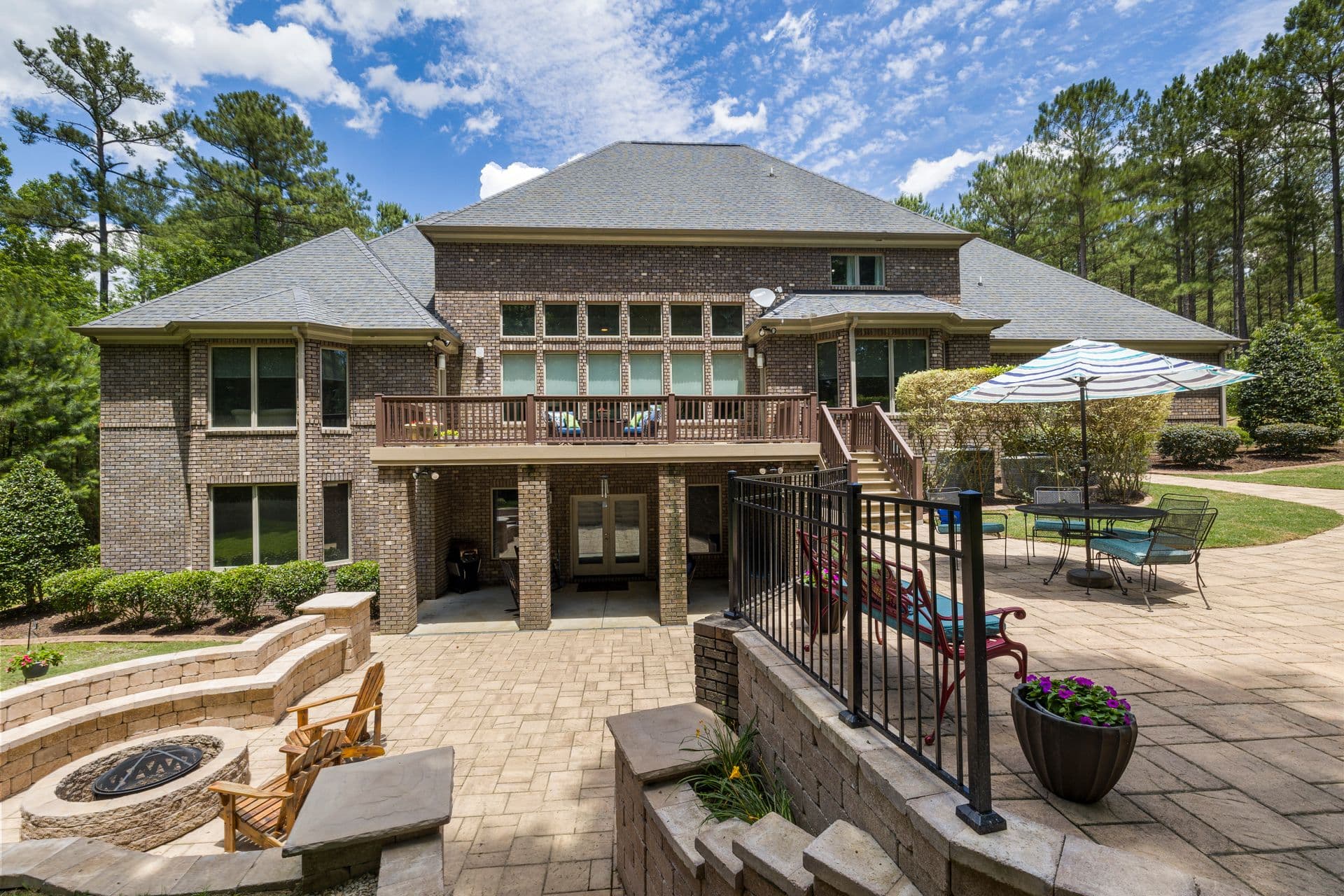 Interlocking paver stone patio in a landscaped backyard