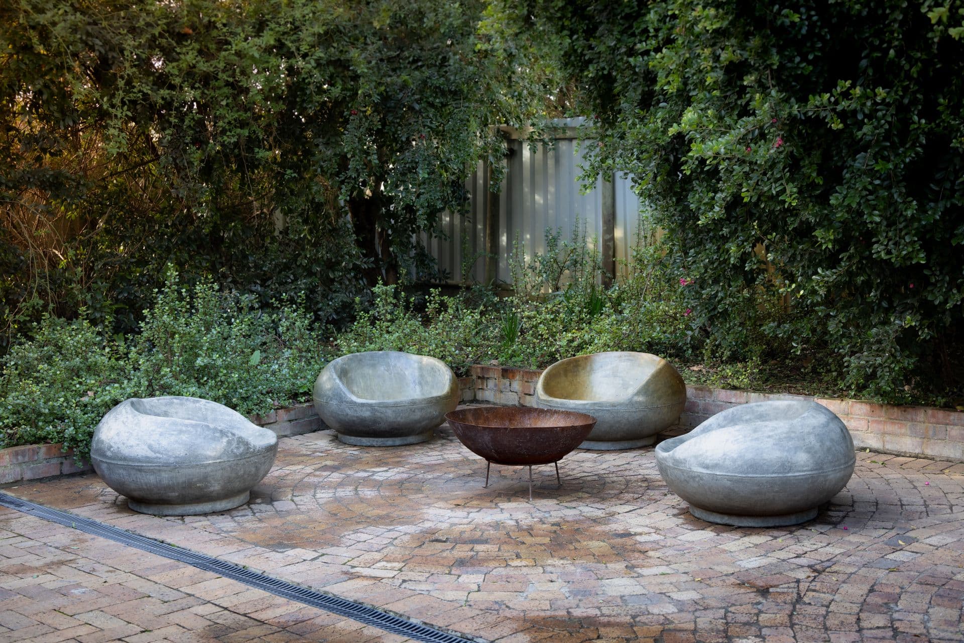 Stone fire pit on a paver patio with outdoor seating