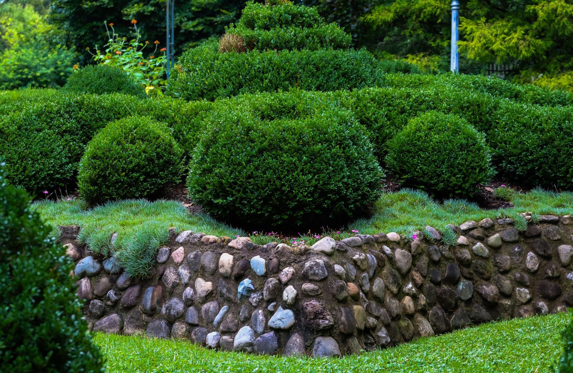 Fieldstone retaining wall bordering a landscaped garden